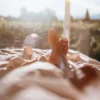 Person resting outdoors with vineyard and mountain views in Mendoza
