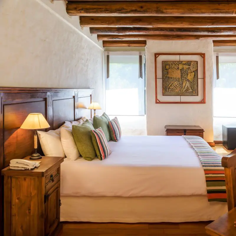 Boutique hotel bedroom with wooden beams in Mendoza.