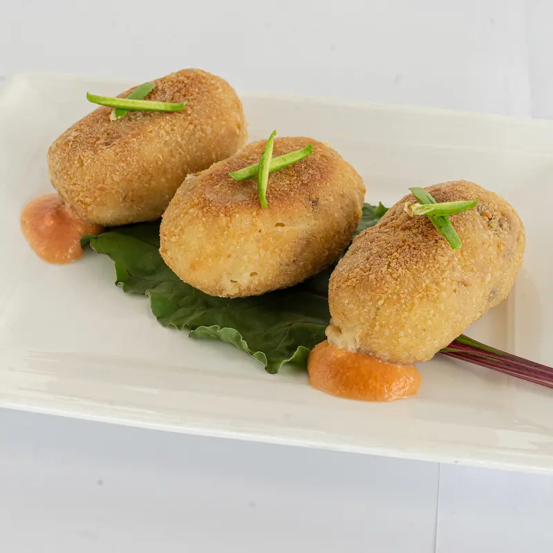 Golden croquettes served over chard leaves with a smoky kick.