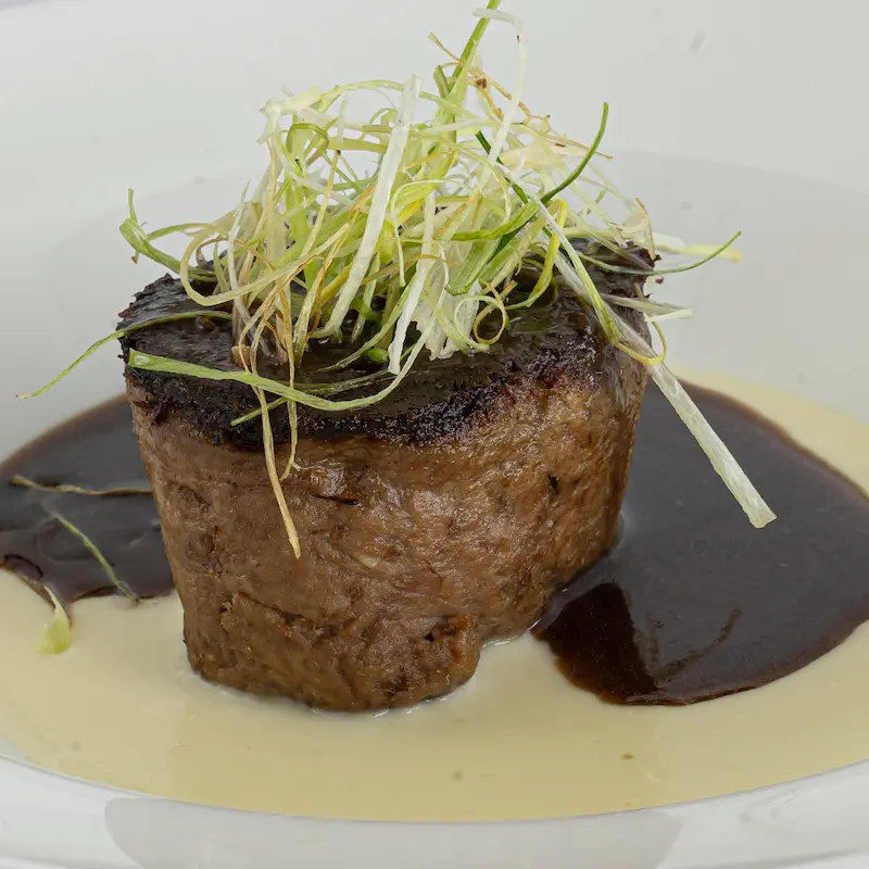 Signature dish with local beef, paired with a rich Malbec sauce.