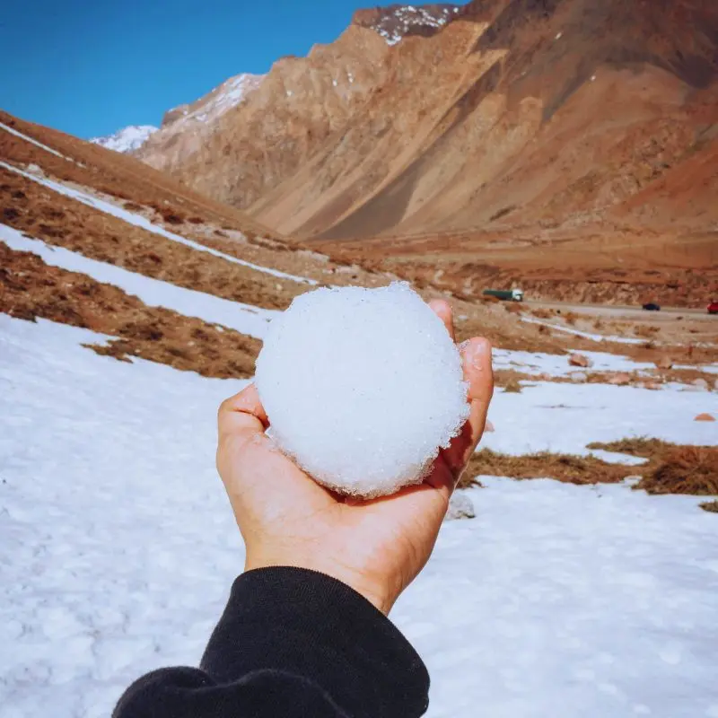 Holding a fresh snowball in the high mountains of Mendoza