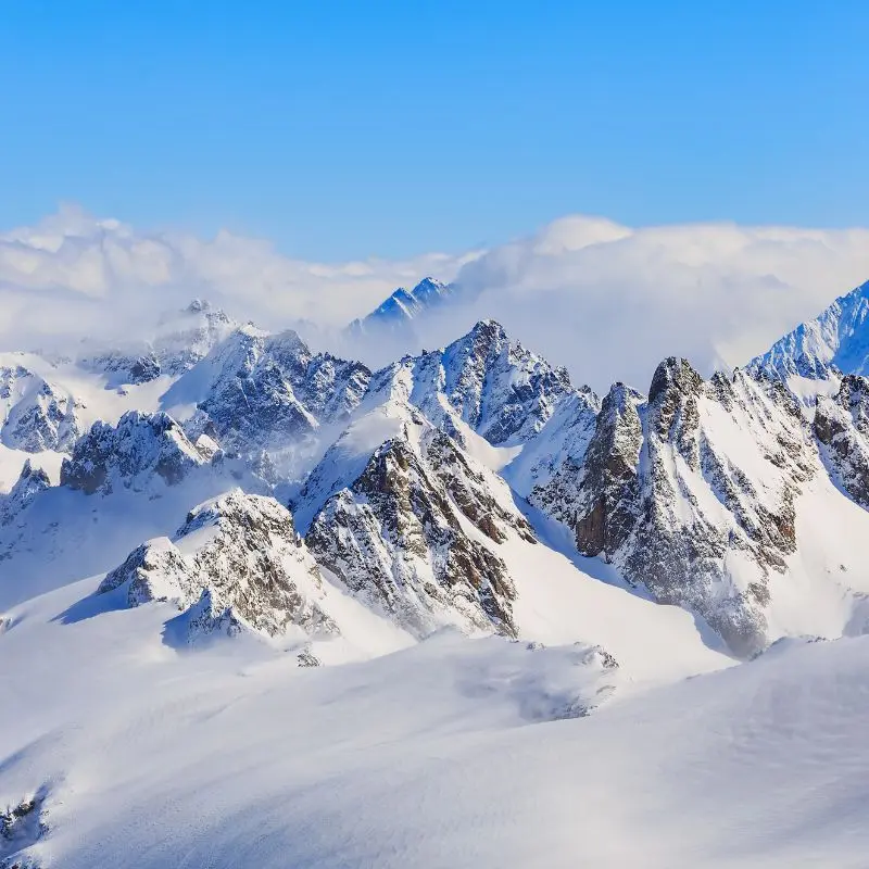 Snow-covered Andes peaks under a clear blue sky
