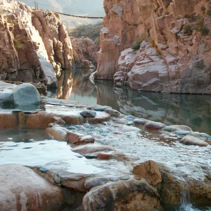 Natural thermal river pools at Termas de Cacheuta canyon