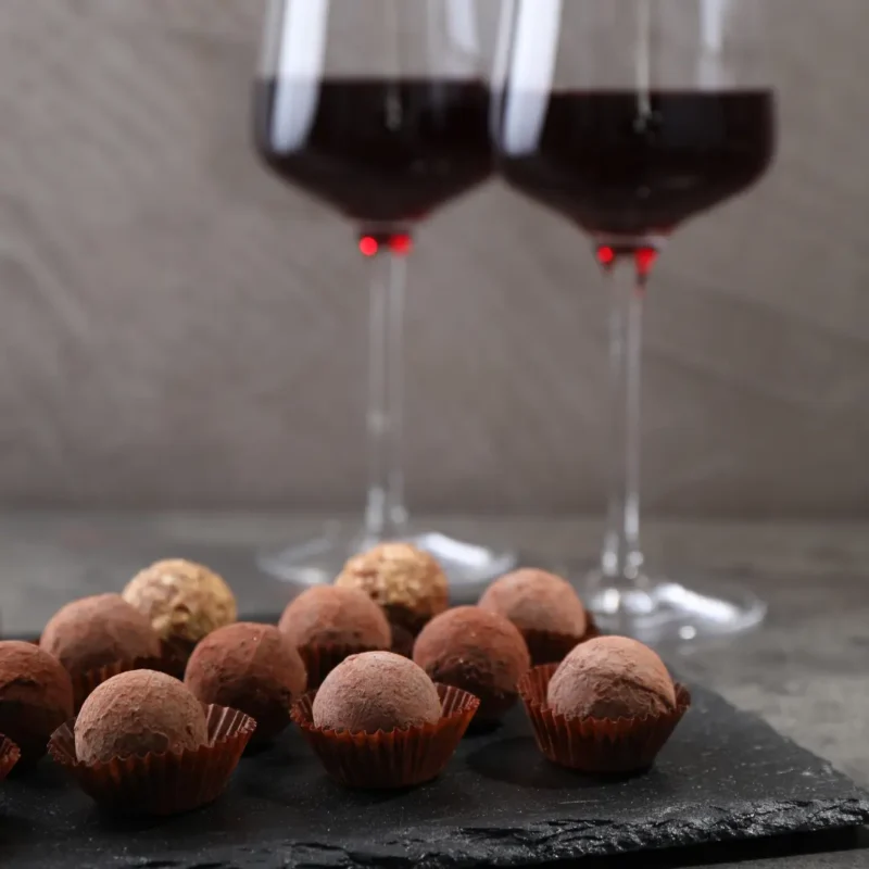 Wine and chocolate pairing in Mendoza with red wine glasses and artisanal truffles