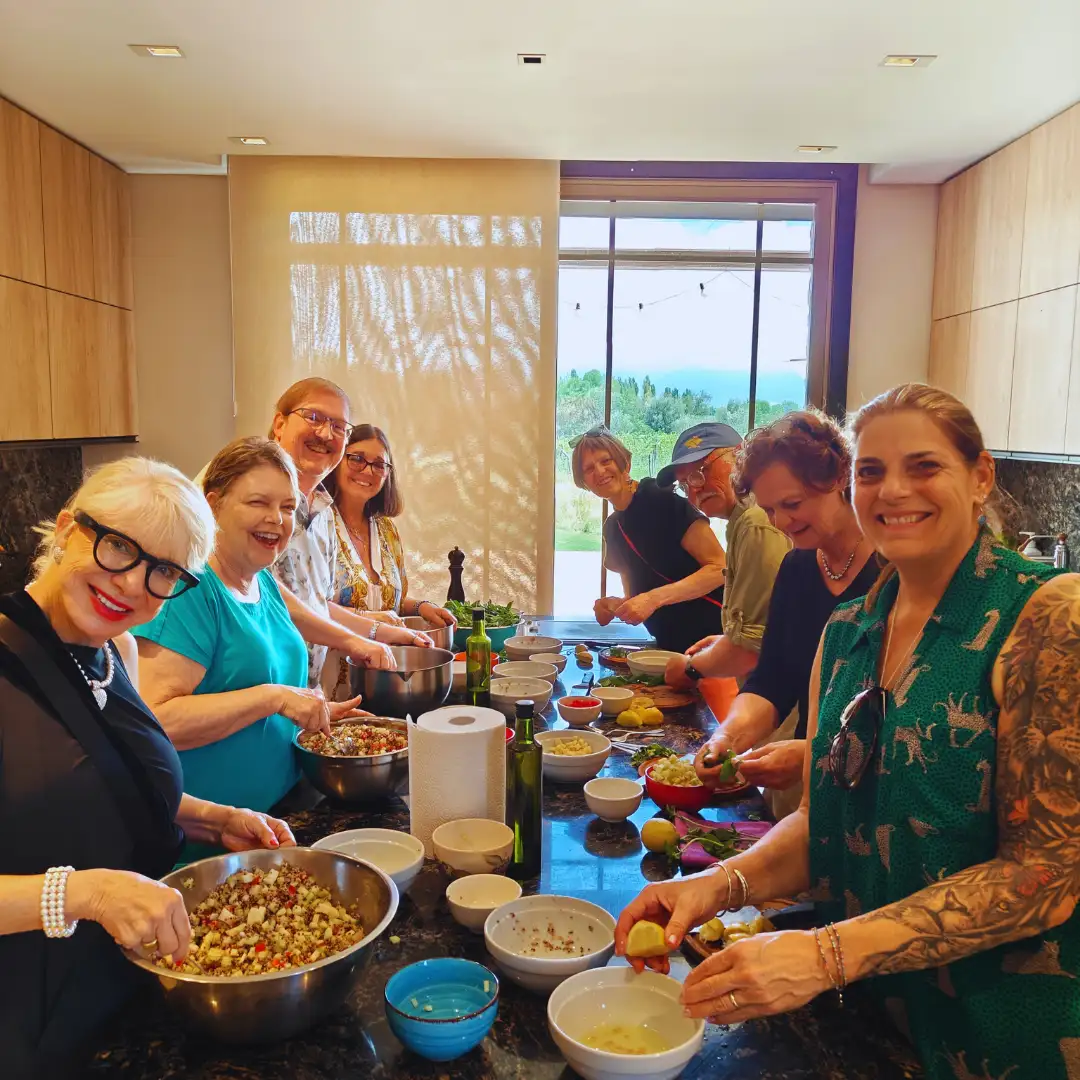 Guests preparing traditional Argentine recipes during a cooking class in Mendoza.